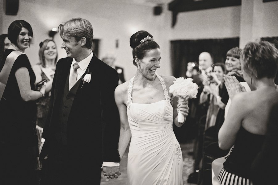 Bride and groom walking down aisle smiling
