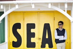 Person standing by yellow SEA doors