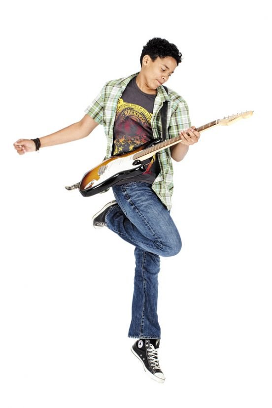 Person jumping while playing electric guitar