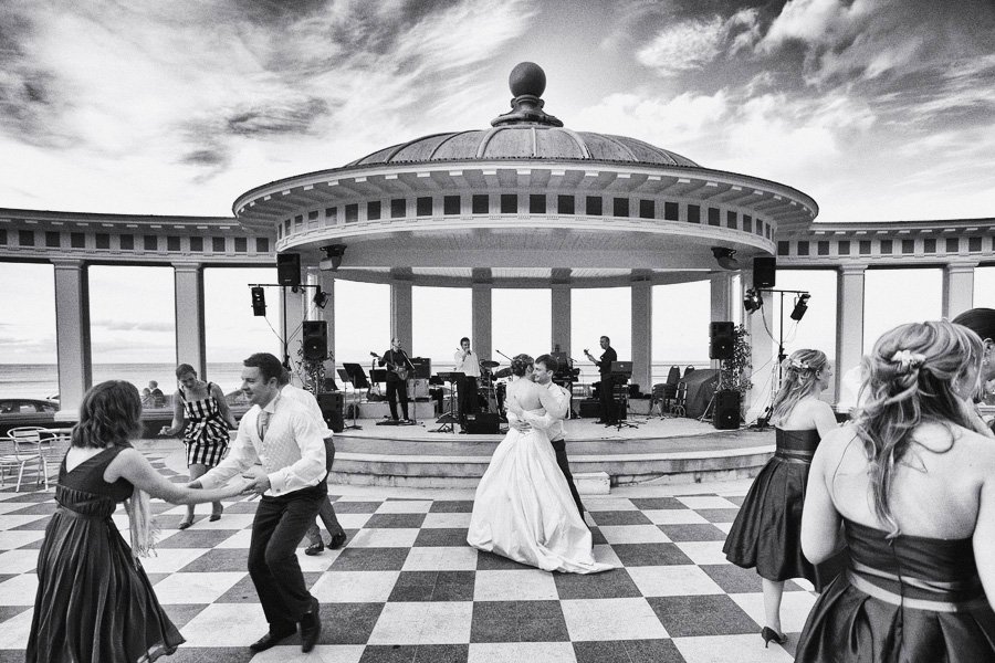 Bride and groom dancing at waterfront wedding reception