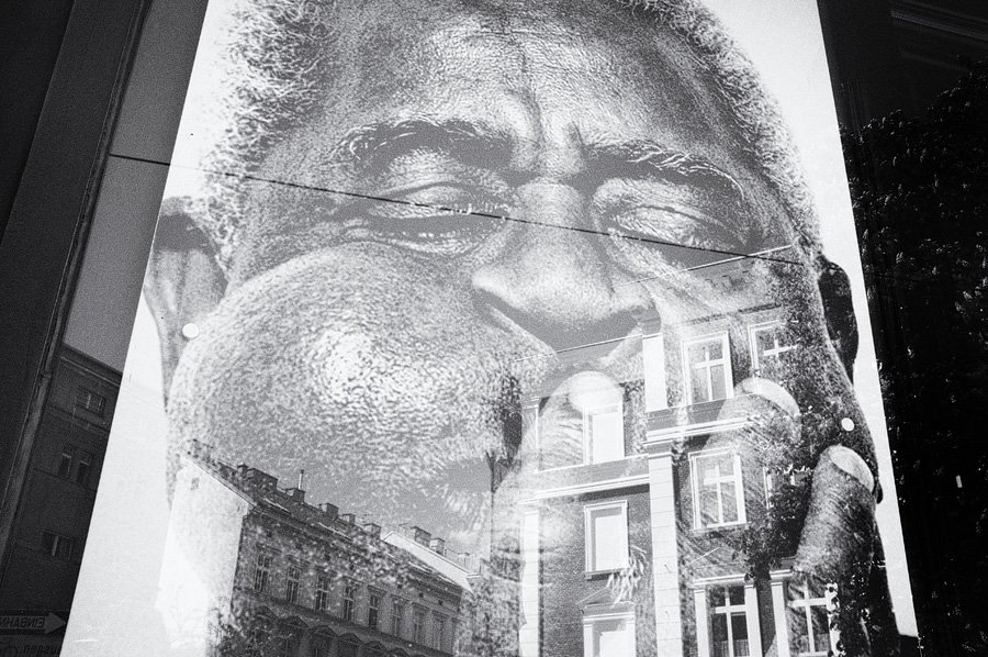 Large black-and-white mural of elderly man's face