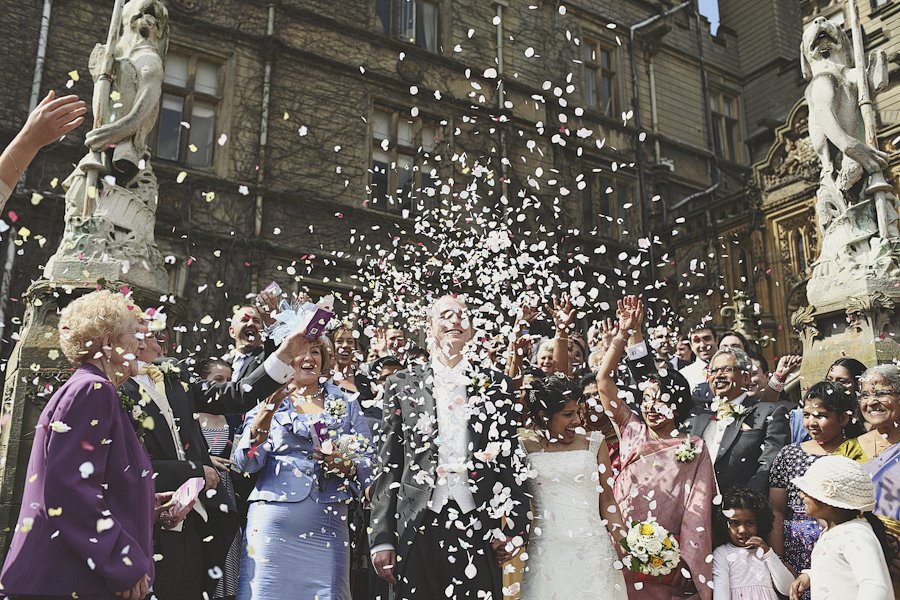 Bride and groom showered with confetti outside church