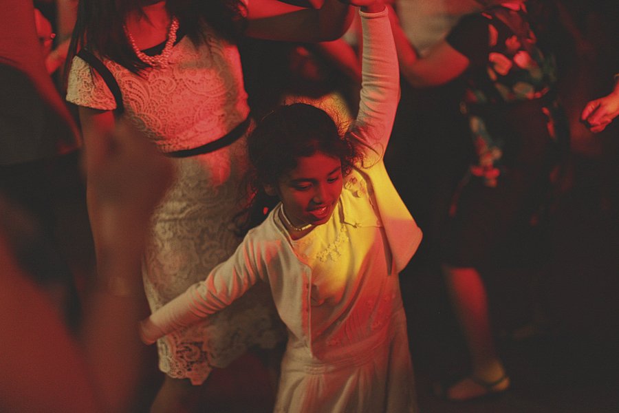 Young girl dancing under red party lights