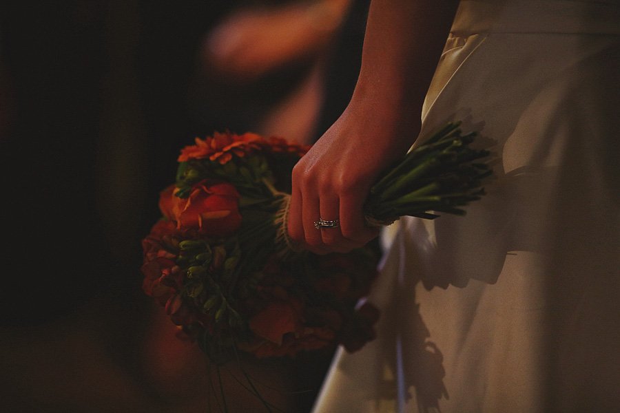 Bride holding bouquet with wedding ring visible
