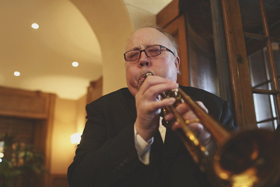 Man playing trumpet indoors