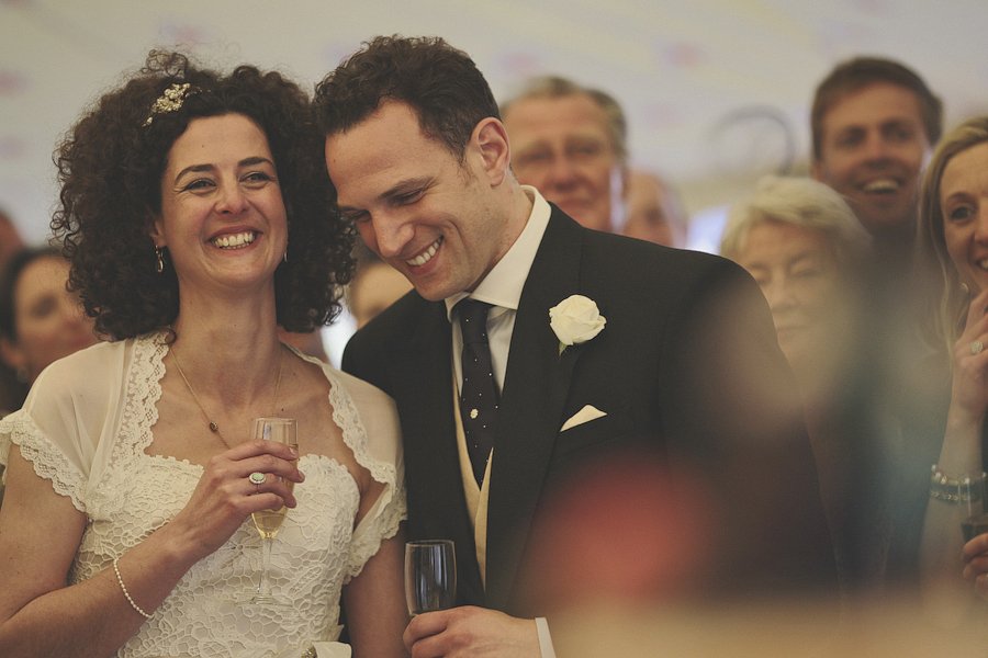 Bride and groom smiling at wedding reception