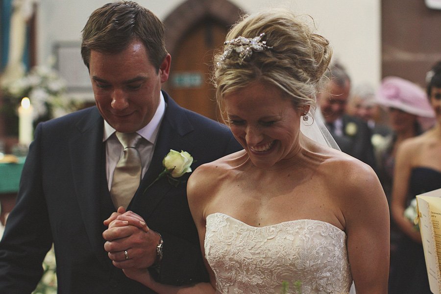 Bride and groom holding hands during wedding ceremony