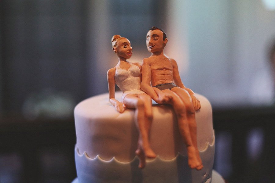 Bride and groom figurines sitting on cake