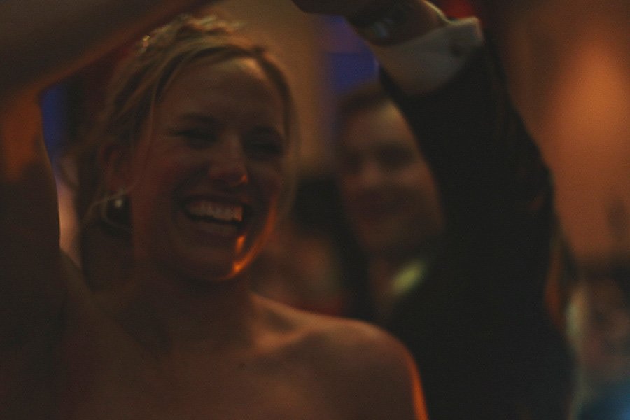 Woman smiling and dancing at dimly lit event