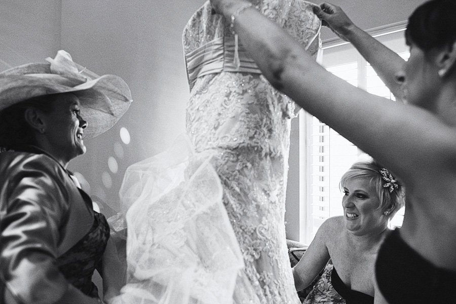 Women admiring wedding dress indoors