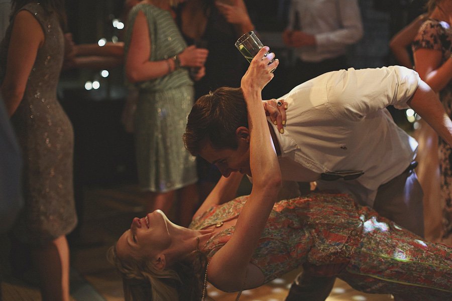 Man dips woman dancing at lively party