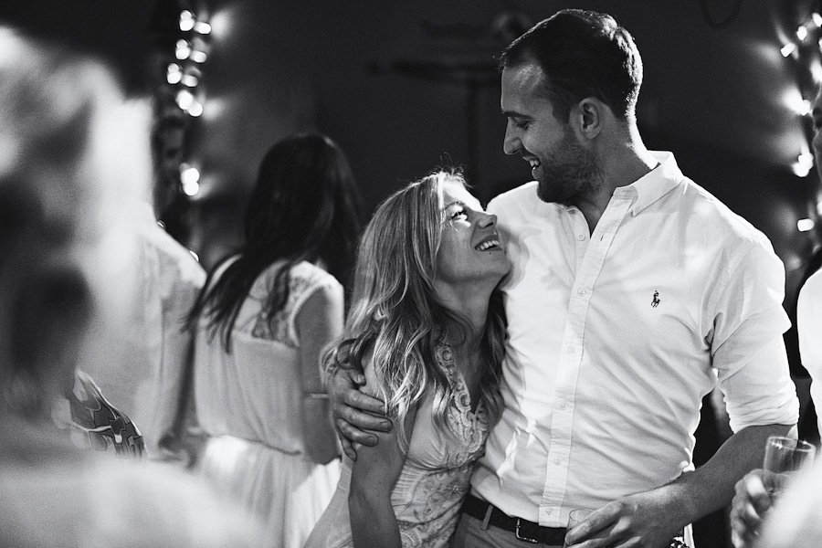 Couple embracing and smiling at party