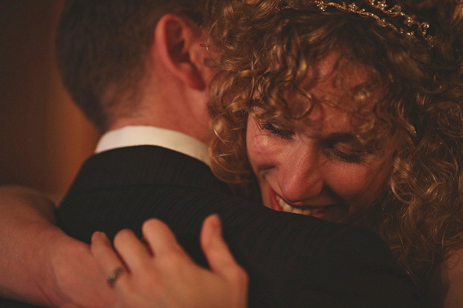Bride and groom sharing emotional embrace
