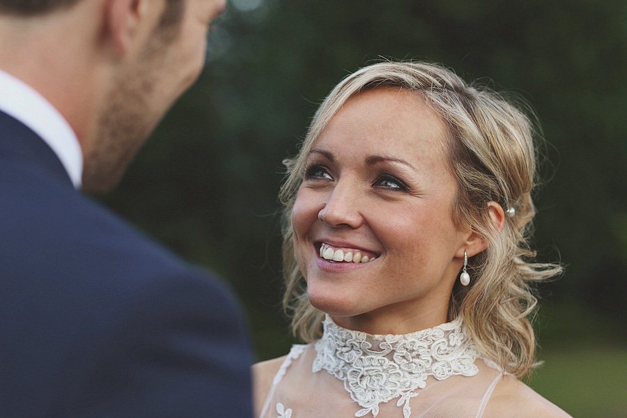 Bride smiling at groom during outdoor wedding