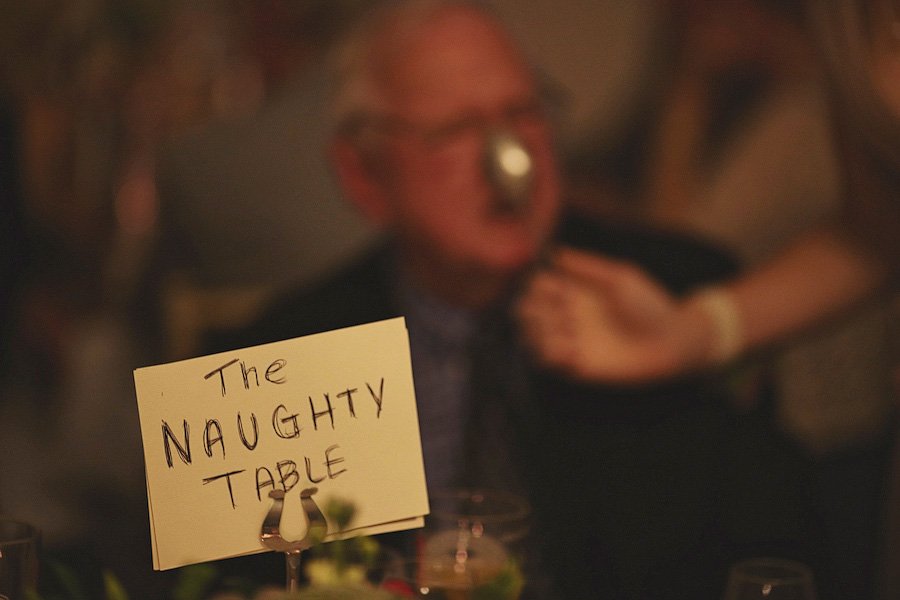 Sign reading 'The Naughty Table' at dinner