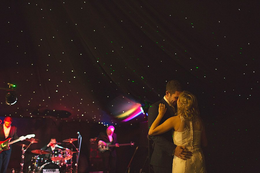 Bride and groom dancing under starry lights