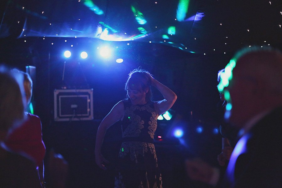 Woman dancing under blue party lights