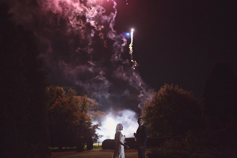 Couple watching fireworks at night outdoors