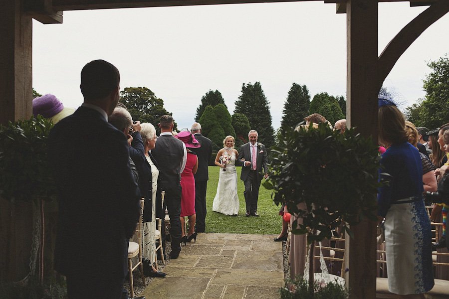Bride walking down aisle at outdoor wedding ceremony