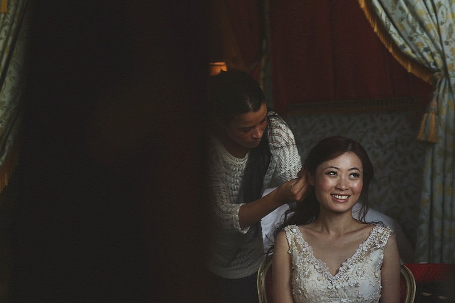 Bride getting hair styled before wedding ceremony