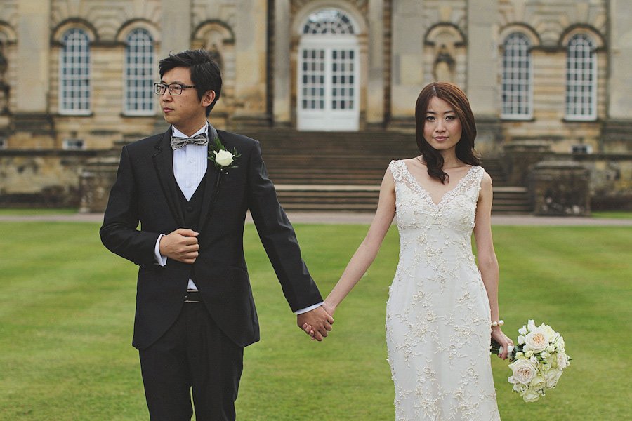 Bride and groom holding hands outdoors