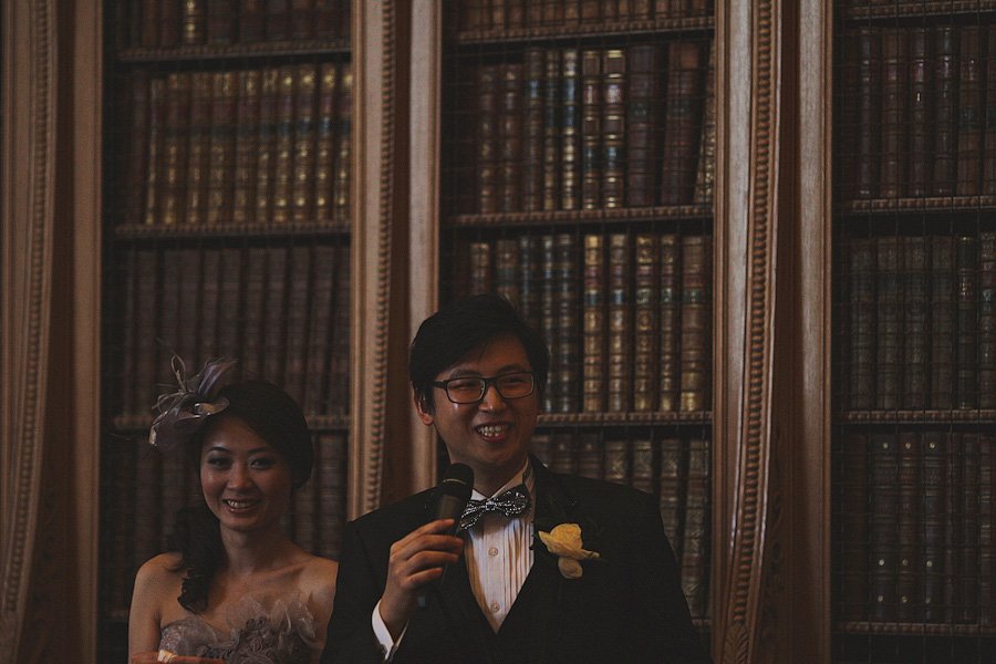 Bride and groom giving speech in library