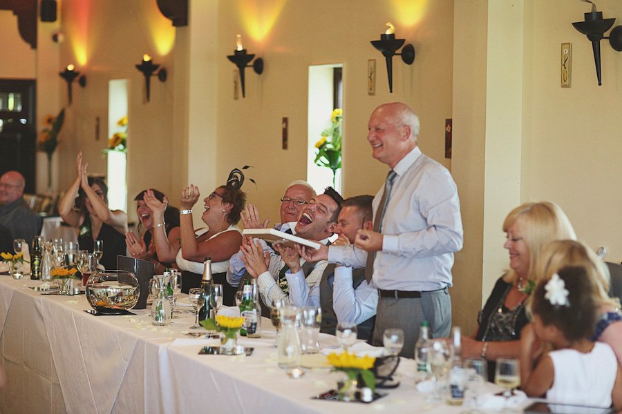 Wedding guests laughing during reception speech
