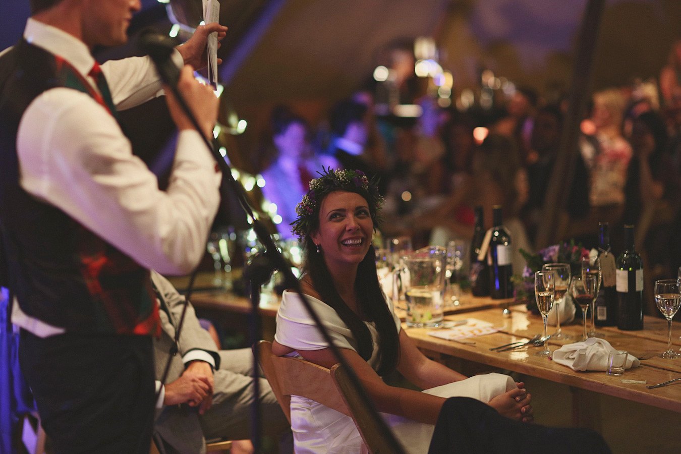 Bride smiling during wedding reception speech