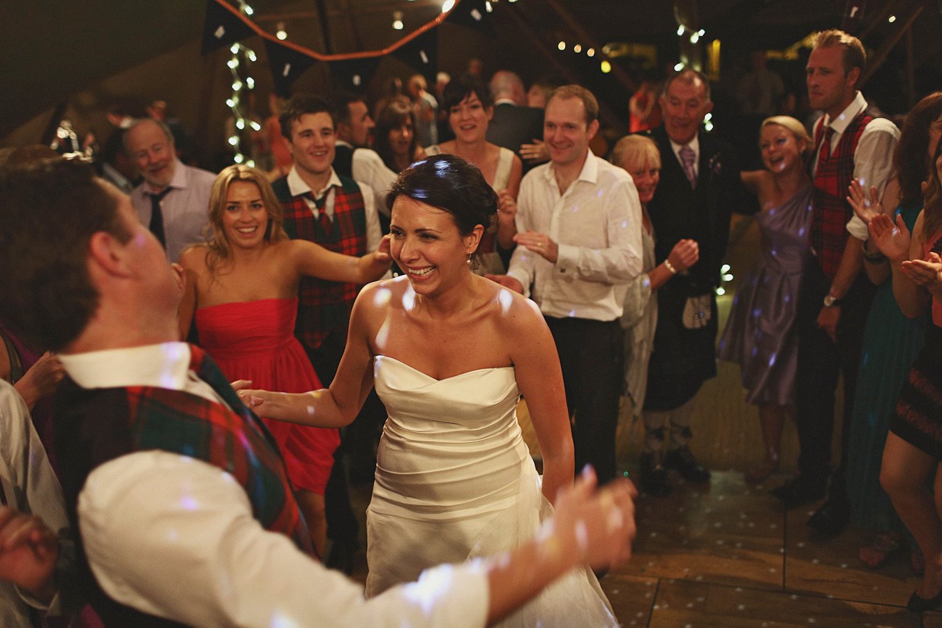 Bride dancing with guests at wedding reception