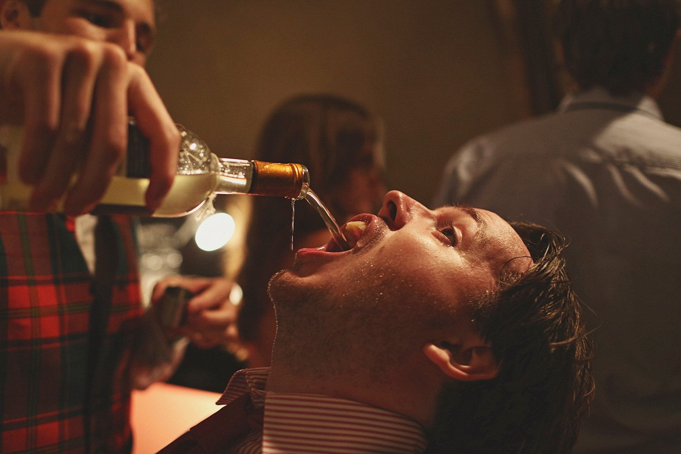 Person being poured liquor at party