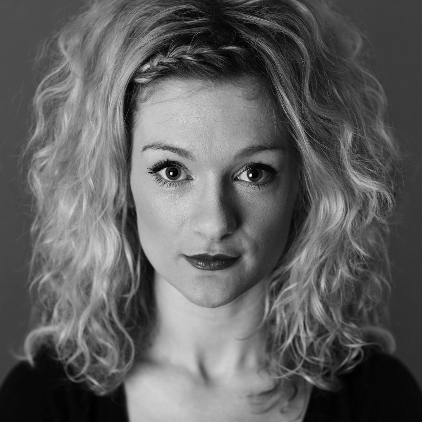 Black and white portrait of curly-haired woman