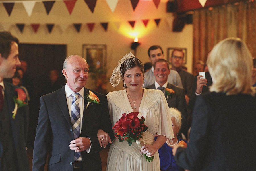 Bride walking down aisle with older man