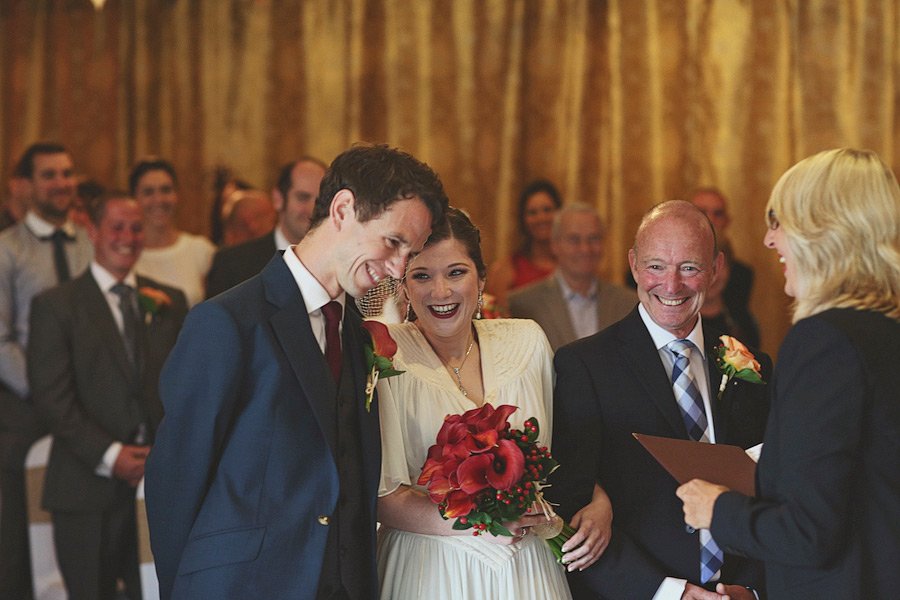 Bride and groom smiling during wedding ceremony
