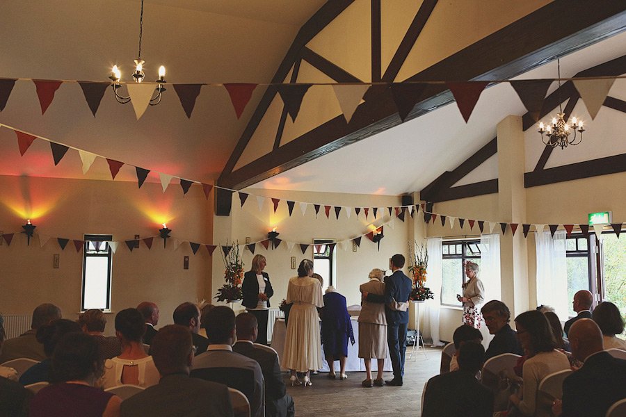 Indoor wedding ceremony with guests and bunting decorations