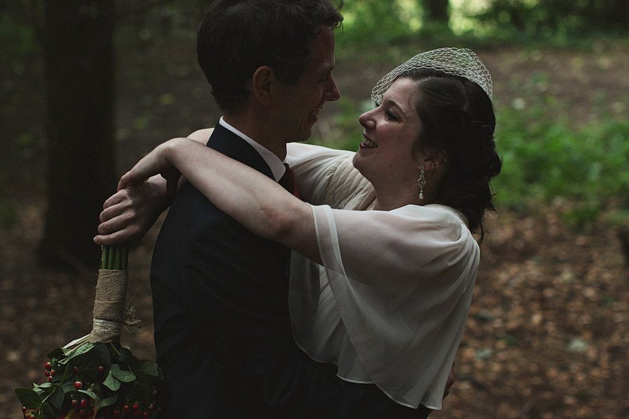 Couple embracing in forest wedding setting