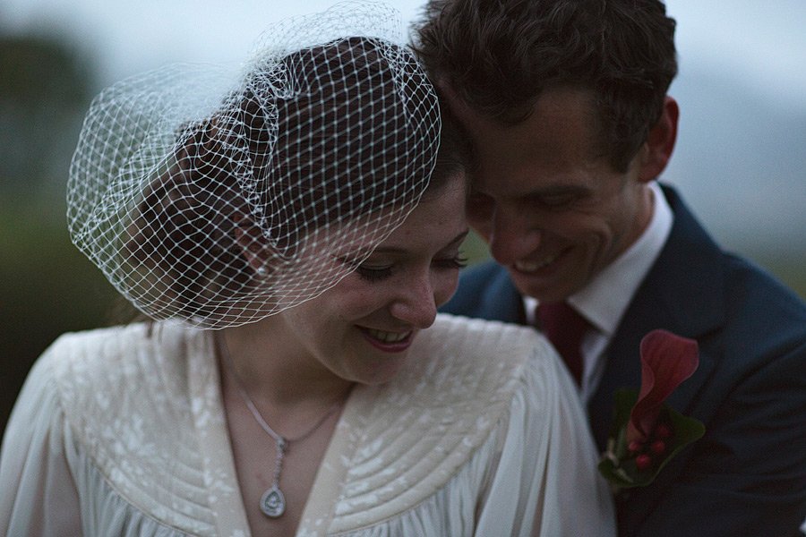 Bride and groom smiling closely together