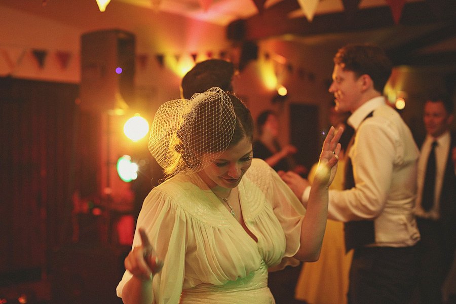 Woman dancing at warmly lit indoor party