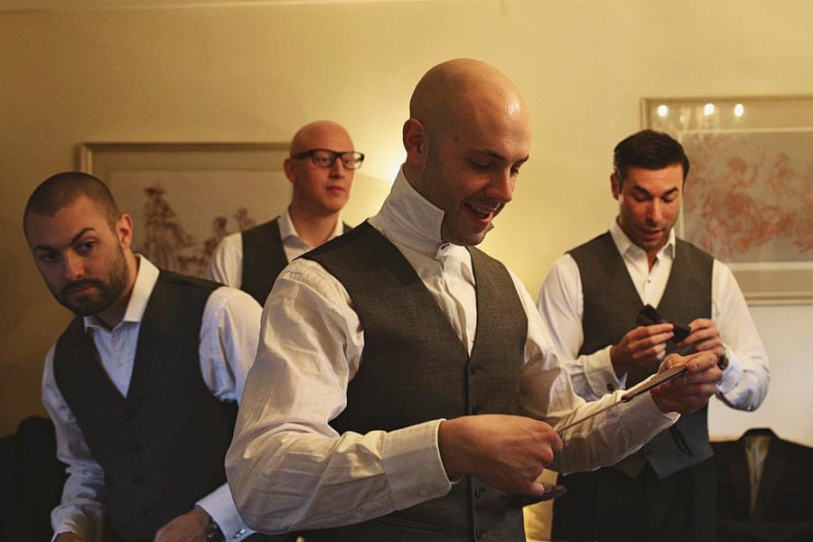 Four men in vests preparing indoors