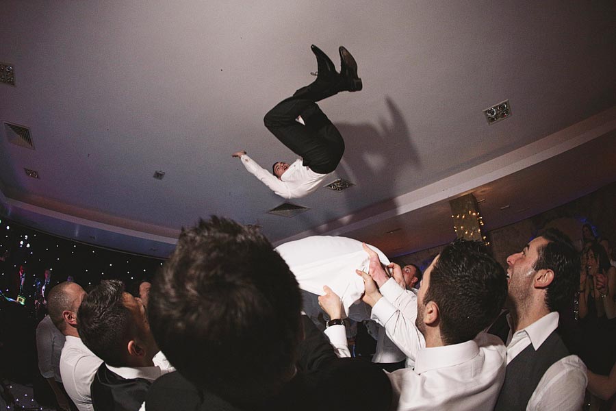 Man flipping midair at wedding celebration