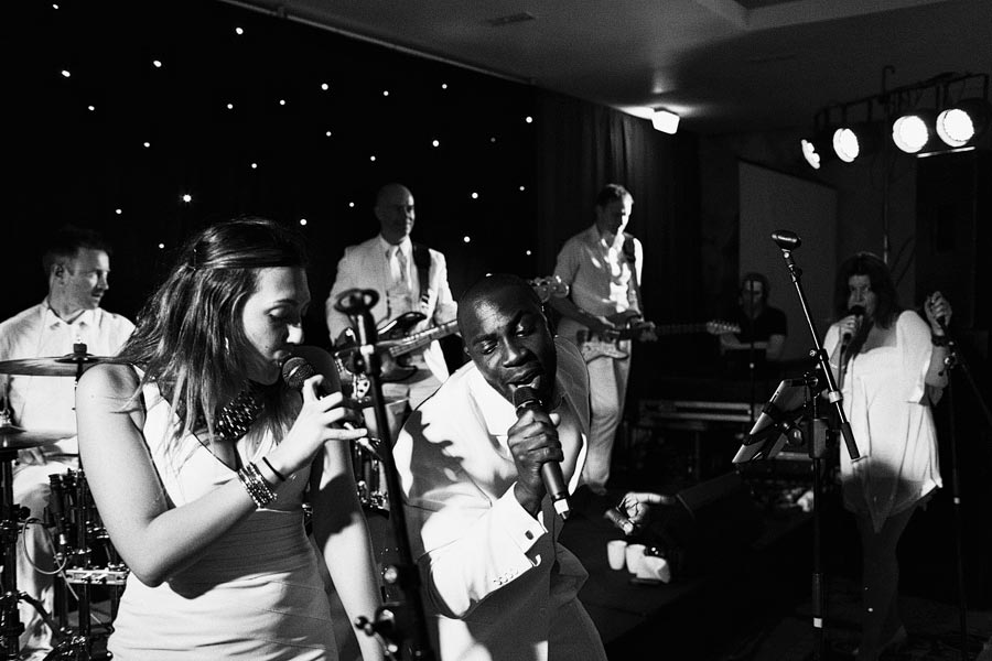 Live band performing on stage with singers