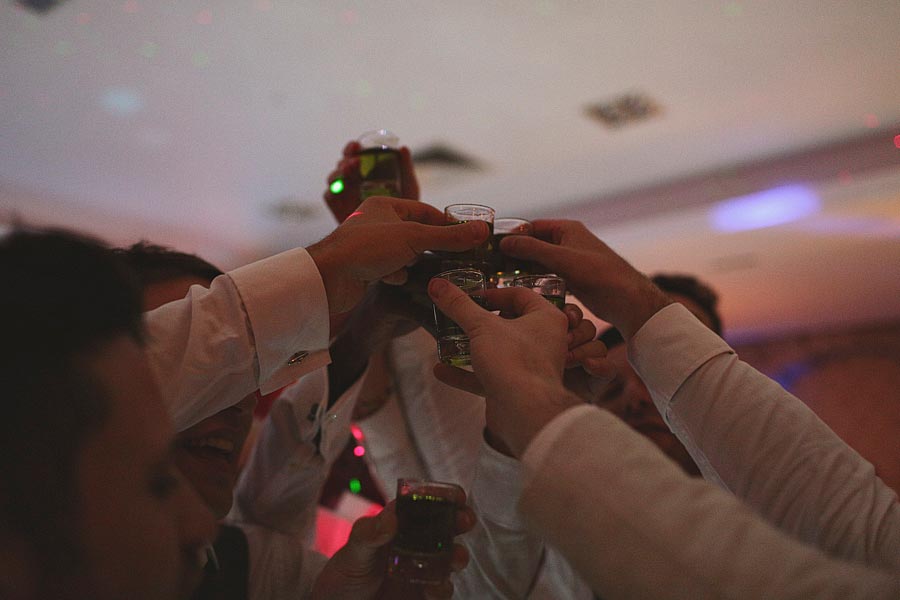 Friends toasting with shots at a party