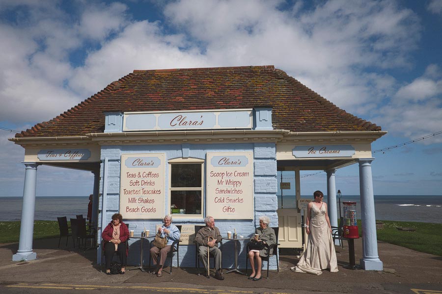 Seaside cafe with elderly people and bride