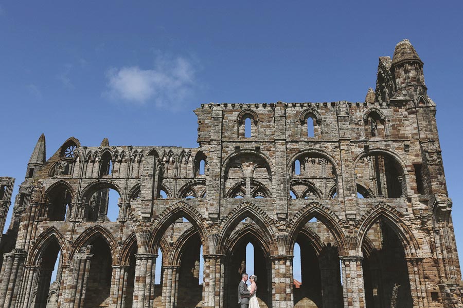 Couple beneath historic Gothic cathedral ruins