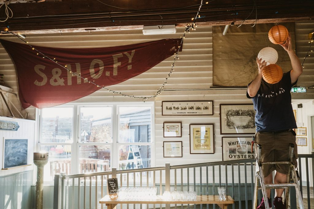 Street Style Wedding Photograph of wedding preparations at Whitstable's East Quay Wedding Venue