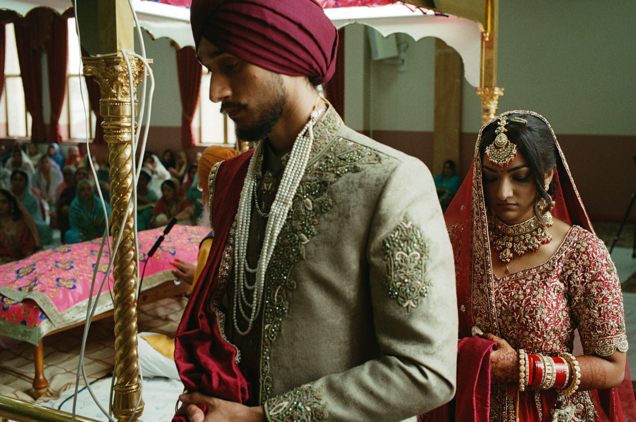 Sikh bride and groom walking together in traditional wedding clothing during their Laavaan
