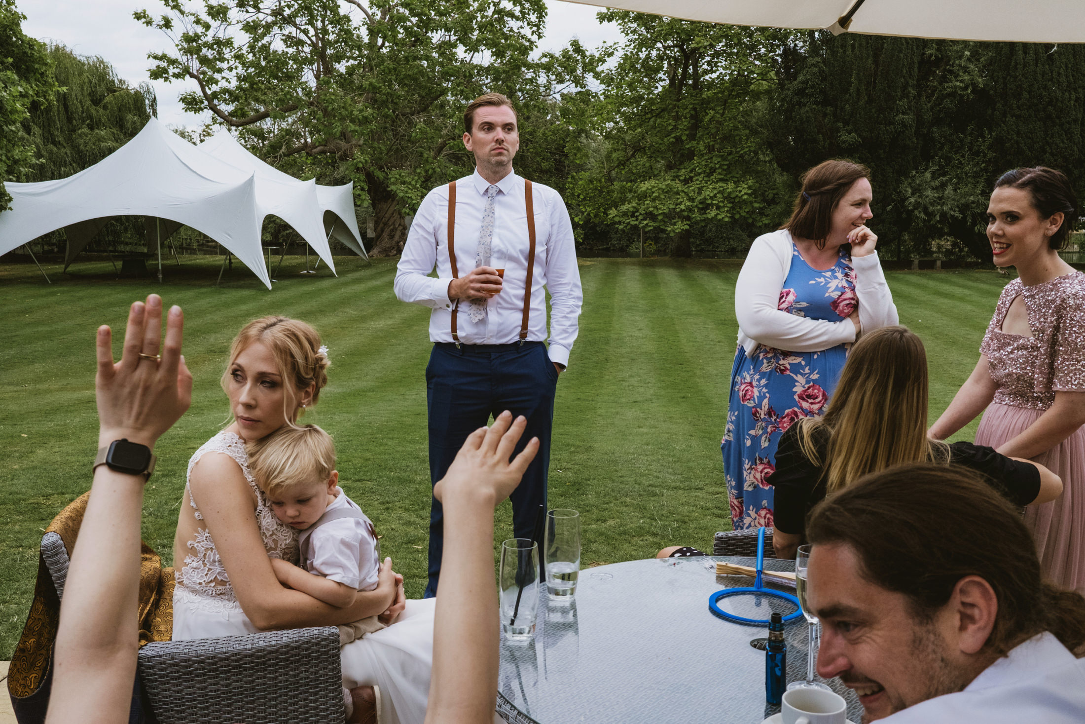 Group of people at outdoor event, grass and tents