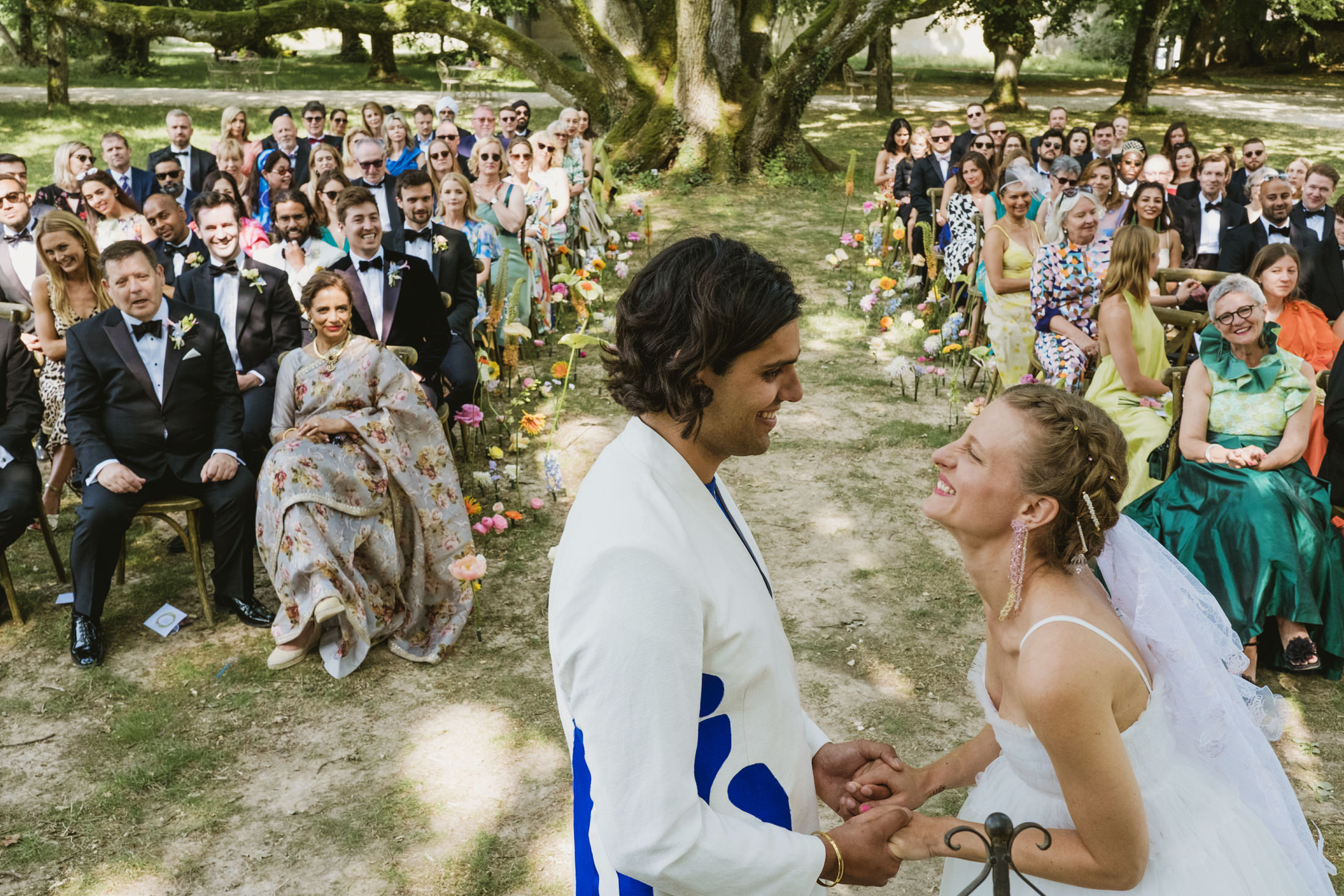 The bride smiling excitedly at her groom in the Chateau du Fey wedding ceremony in France