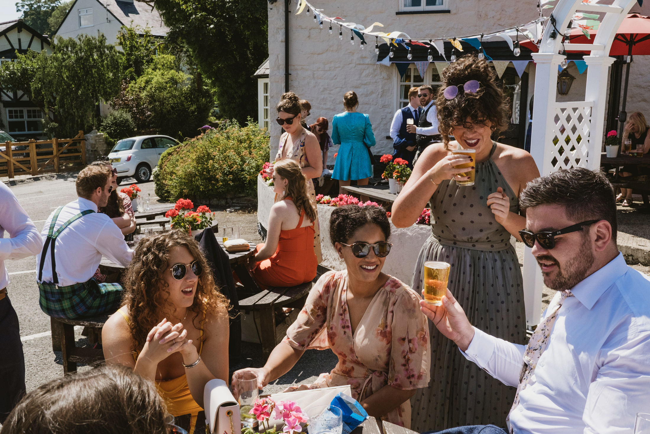 Outdoor gathering at a pub with people socialising.