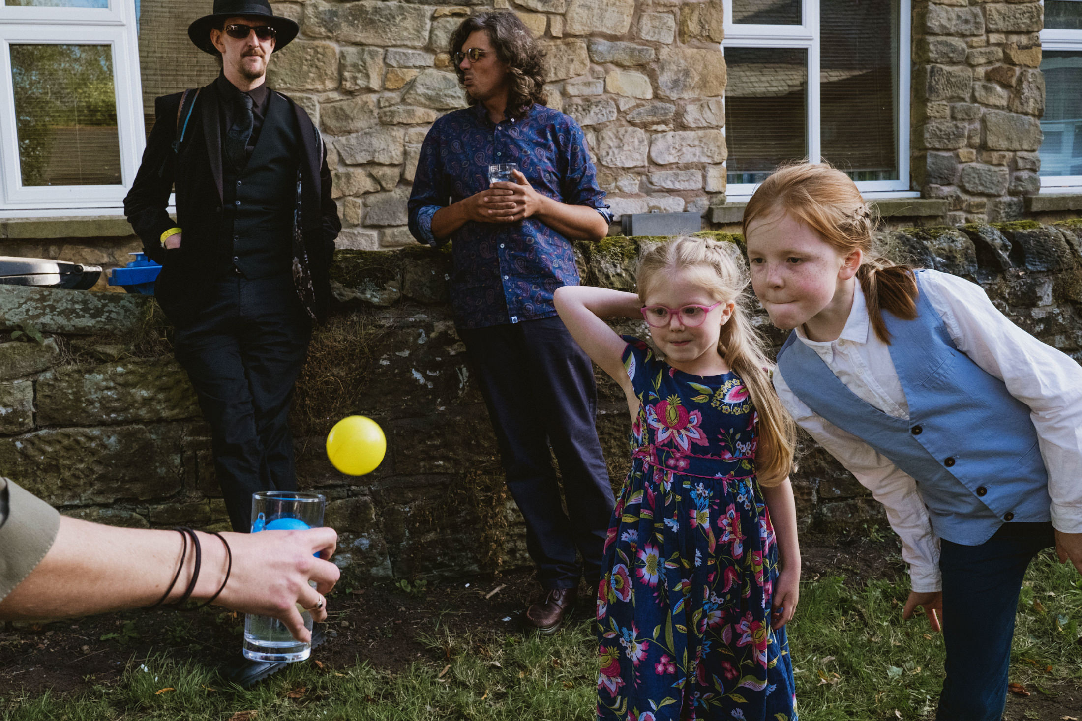 Children playing toss ball game outside