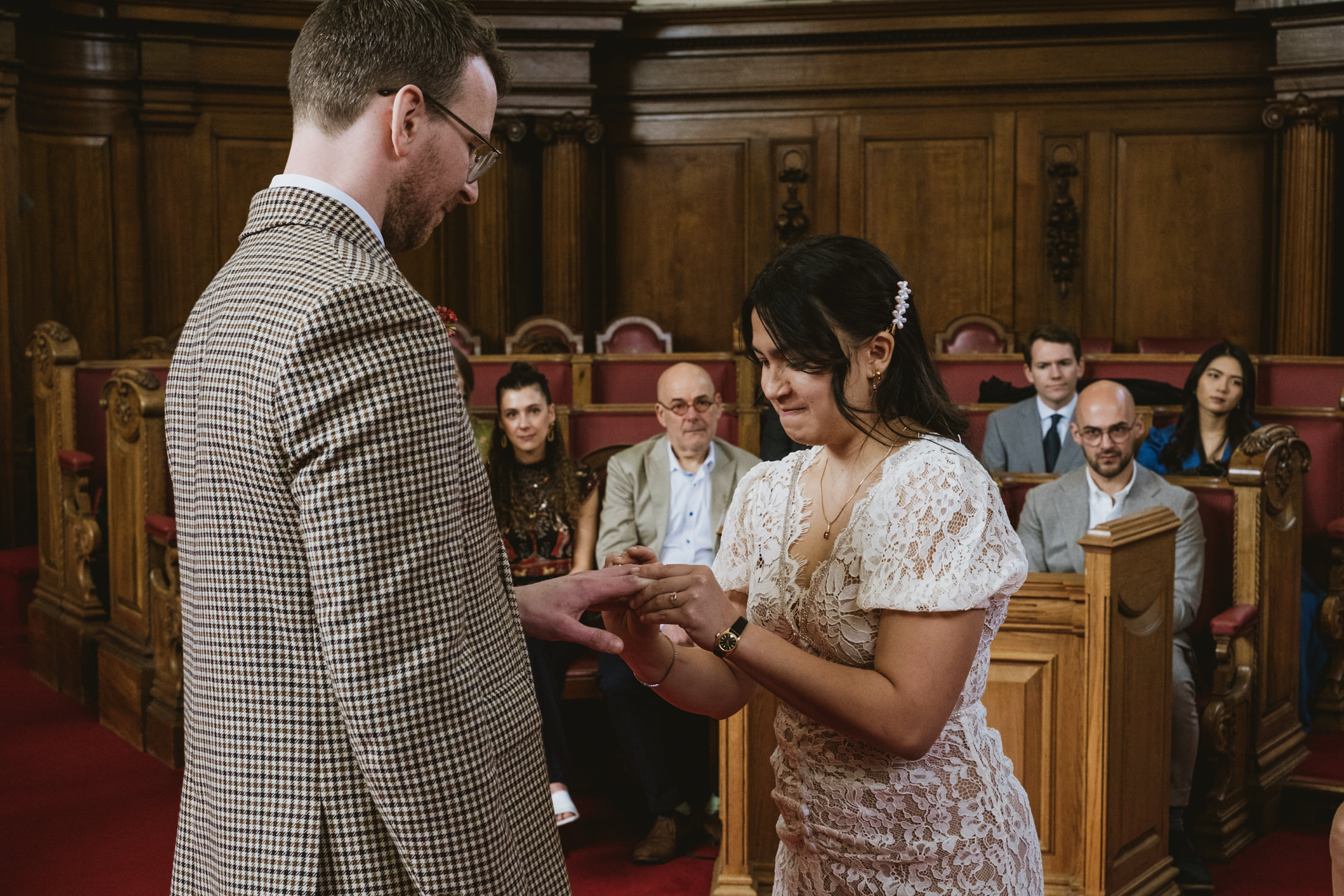 Couple exchanging rings during wedding ceremony.